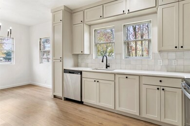 Kitchen with dishwasher, tasteful backsplash, plenty of natural light, and sink