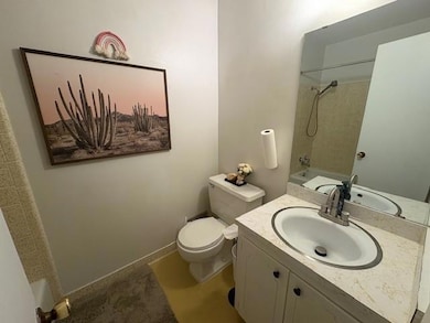 Bathroom featuring toilet, vanity, and  shower combination