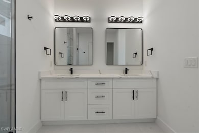Bathroom featuring tile patterned floors, vanity,