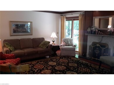 WARM FAMILY ROOM WITH WOOD BURNING FIREPLACE AND PELLA SLIDER TO PATIO