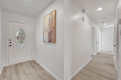 Foyer with light hardwood / wood-style flooring