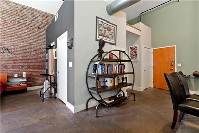 Office with finished concrete flooring, visible ve