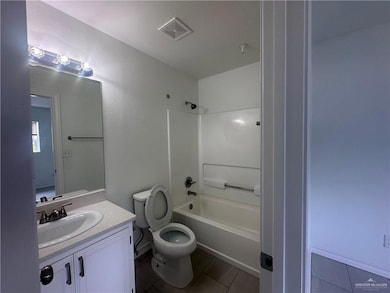 Bathroom featuring vanity, shower / tub combination, and tile patterned floors