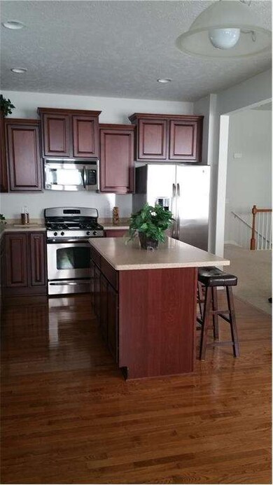 Beautiful hard wood flooring & staggered cabinets.