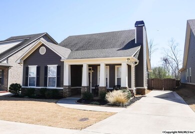 The side driveway is concrete and leads around to a rear double garage.
