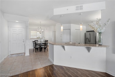 Kitchen featuring kitchen peninsula, pendant light