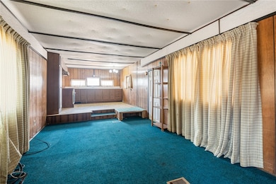 Miscellaneous room featuring wood walls, a texture