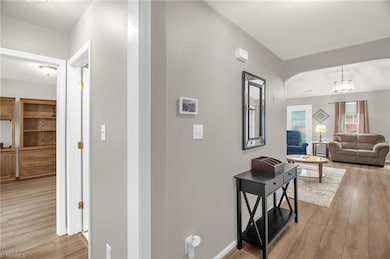 Foyer view showing bedroom 2 and hall bath to the left and into the living room on the right.