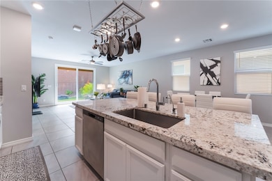 Kitchen featuring open floor plan, a sink, stainle