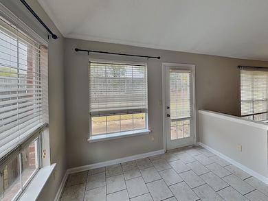 Doorway to outside with tile patterned flooring and a textured ceiling