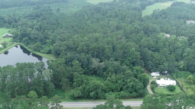 View of property location featuring a heavily wooded area and a large body of water