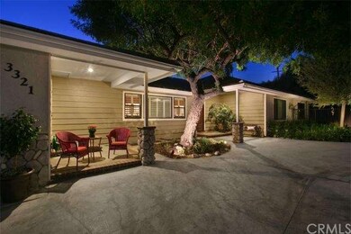 Inviting front porch and mature Pepper tree enhanc