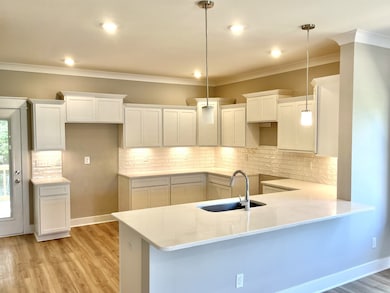 Stock photo Lots of room in kitchen to cook or gather. Undercabinet lights sparkle on textured backsplash