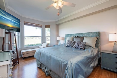 Bedroom featuring ornamental molding, wood finished floors, and ceiling fan