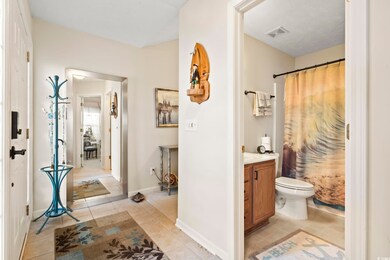 Bathroom with tile patterned flooring, vanity, toi