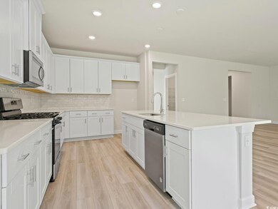 Kitchen with stainless steel appliances, white cab