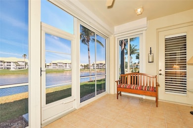Sunroom featuring a water view and tile patterned