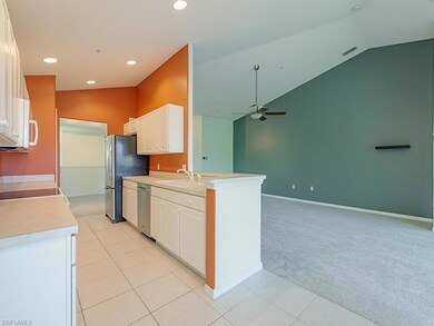 Kitchen with lofted ceiling, light tile patterned 