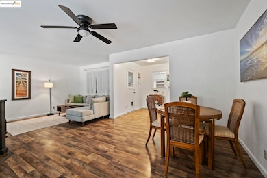 Dining space with wood finished floors and ceiling fan