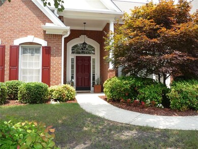 Entrance to property featuring brick siding and a yard