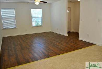 Large living room with laminate floors.