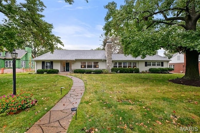 Ranch-style home featuring a front lawn, a chimney, and a porch