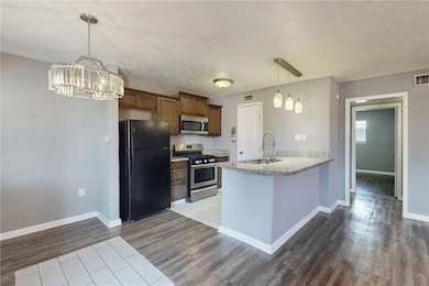 Kitchen featuring sink, an inviting chandelier, ki