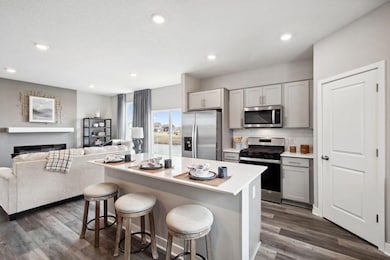 This inviting kitchen features a wide island suitable for family dining or snack time! *Photos are of a previously staged model*