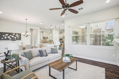 Living room featuring baseboards, ceiling fan, da