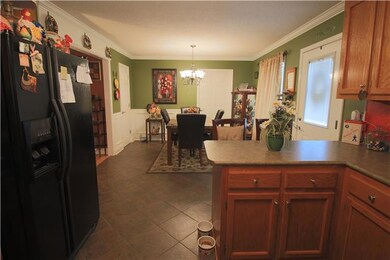 Eat-In Kitchen - With tile flooring, crown molding, chair rail and wainscoting and a pantry.