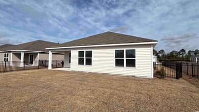 Back of property featuring a yard and a patio area