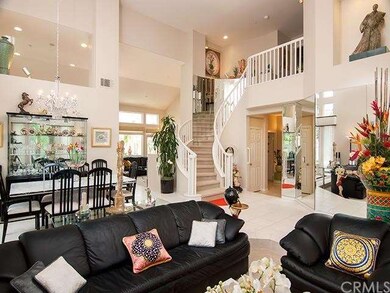 formal living room with soaring ceilings, a windin