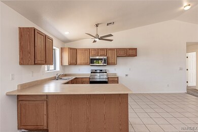 Kitchen with light tile patterned floors, stainles