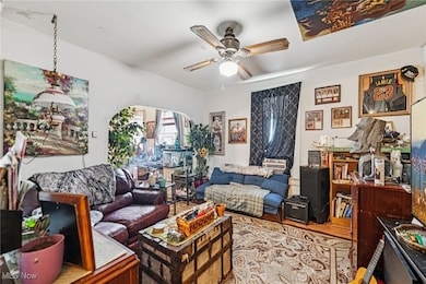 Living room with wood finished floors and a ceiling fan