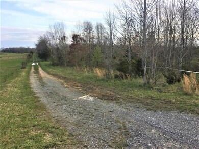 There is a road that goes around the property. There is also a small pond.
