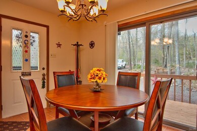 The dining area features a tile floor, chandelier 
