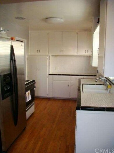 Kitchen with white California tile and wood floors