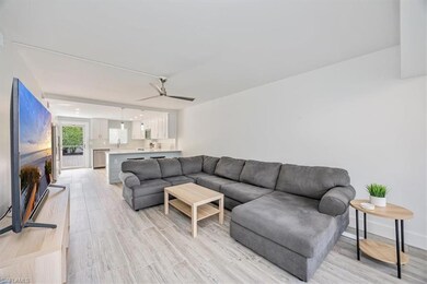Living room with light wood-type flooring and ceiling fan