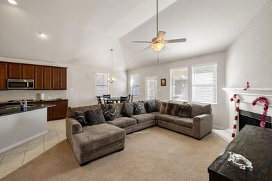 Living room with ceiling fan, light tile patterned