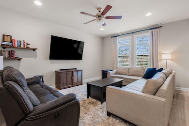Living room with recessed lighting, baseboards, a