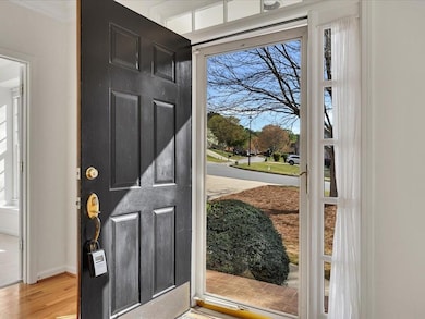 Entrance foyer with baseboards, ornamental molding