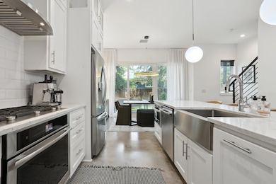 Kitchen featuring stainless steel appliances, a s