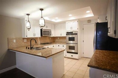 The kitchen also features recessed lights and a ti