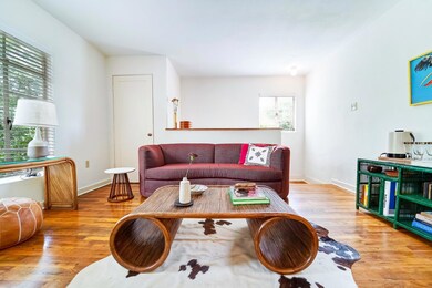 Living room with wood finished floors and baseboa