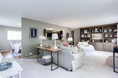 Living area with baseboards and carpet flooring