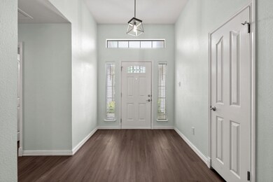 Foyer entrance with dark wood finished floors and