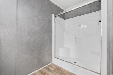 Bathroom with wood finished floors and a shower