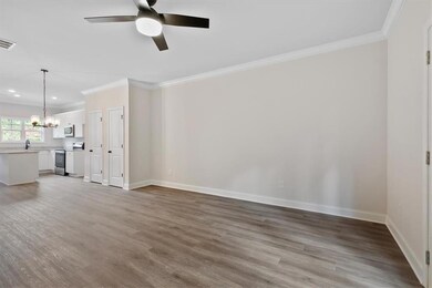 Unfurnished living room featuring ceiling fan with