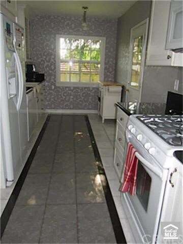 Galley kitchen with nook at far end