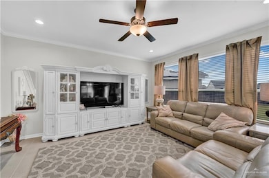 Living room featuring ceiling fan, ornamental molding, light tile patterned floors, and recessed lighting